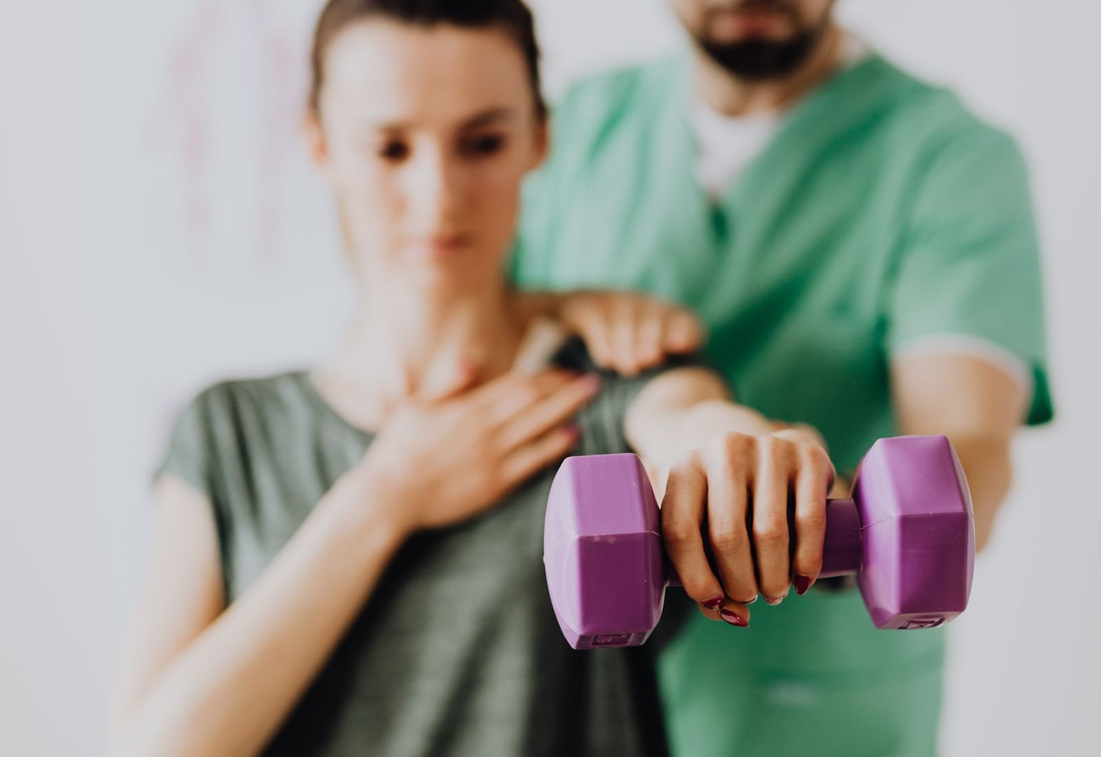 A physiotherapist assessing a patient's movement